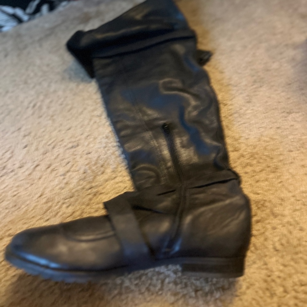 Tall black genuine leather buckle boot. Worn once. Over the knee.Aldo size 39
